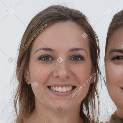 Joyful white young-adult female with long  brown hair and grey eyes