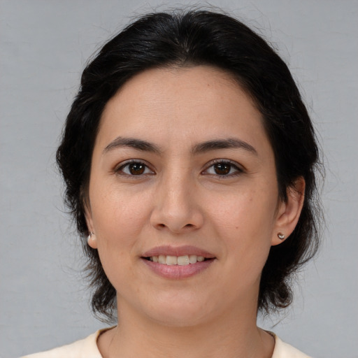 Joyful white young-adult female with medium  brown hair and brown eyes