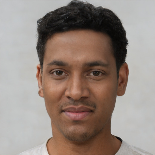 Joyful latino young-adult male with short  black hair and brown eyes