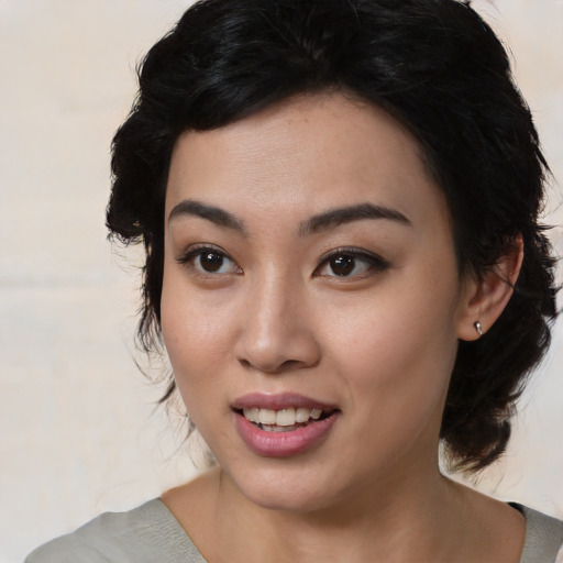 Joyful asian young-adult female with medium  black hair and brown eyes