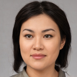 Joyful asian young-adult female with medium  black hair and brown eyes