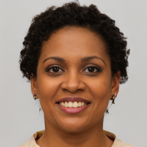 Joyful black young-adult female with short  brown hair and brown eyes