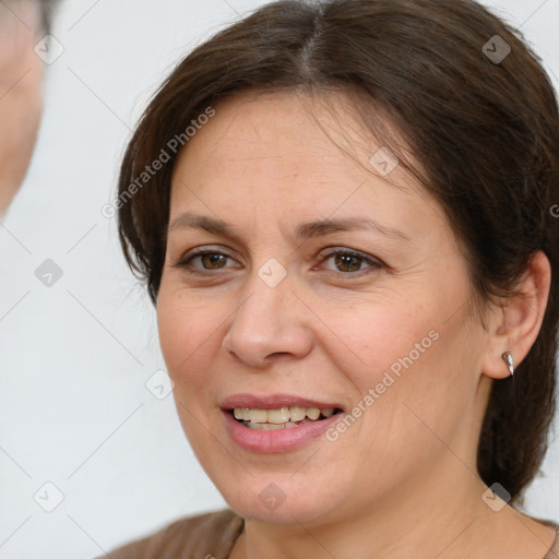 Joyful white adult female with medium  brown hair and brown eyes