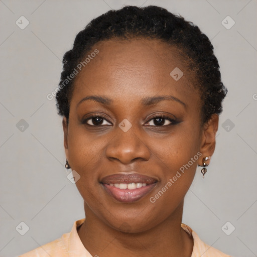 Joyful black young-adult female with short  black hair and brown eyes