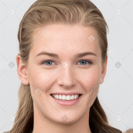 Joyful white young-adult female with long  brown hair and blue eyes