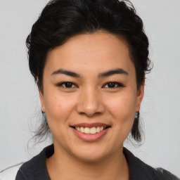 Joyful asian young-adult female with medium  brown hair and brown eyes