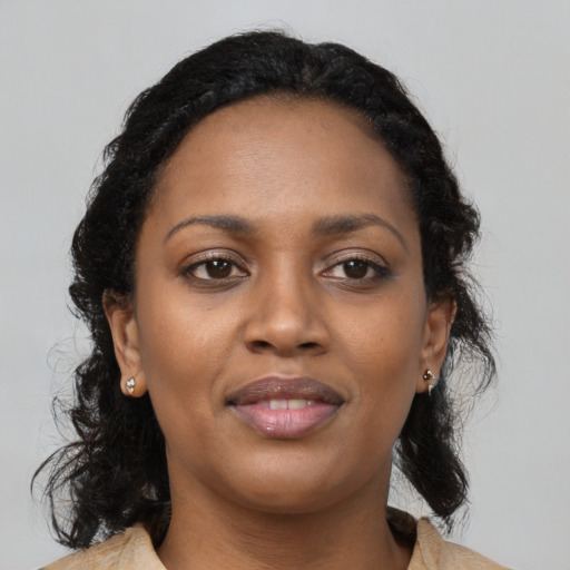 Joyful black young-adult female with medium  black hair and brown eyes