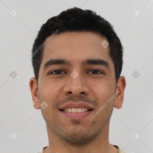 Joyful latino young-adult male with short  black hair and brown eyes