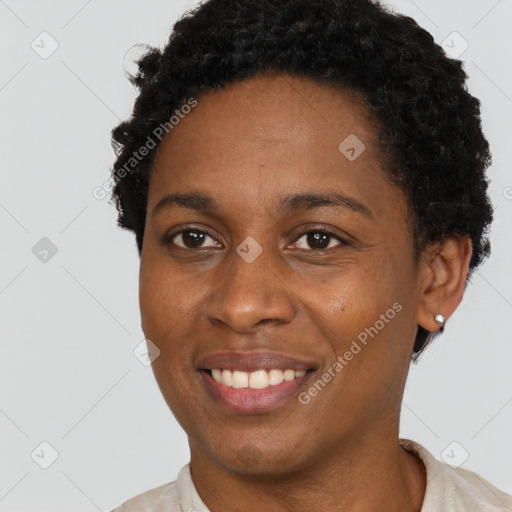 Joyful black young-adult female with short  brown hair and brown eyes