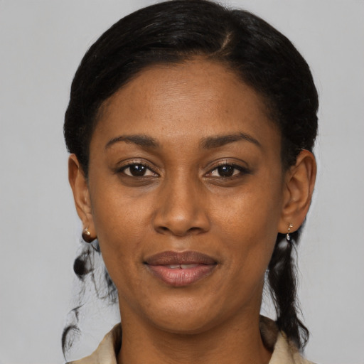 Joyful black adult female with medium  black hair and brown eyes