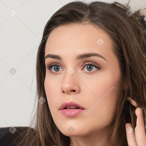 Neutral white young-adult female with long  brown hair and brown eyes