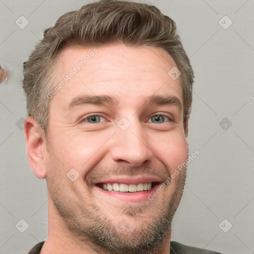 Joyful white young-adult male with short  brown hair and grey eyes