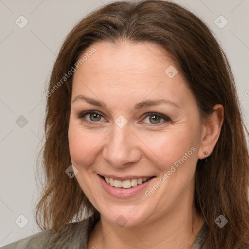 Joyful white adult female with long  brown hair and brown eyes