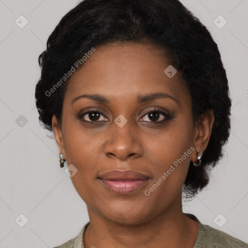 Joyful black adult female with short  brown hair and brown eyes