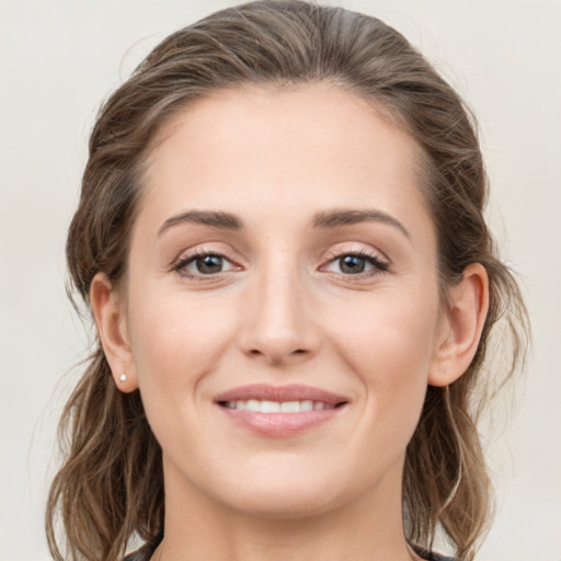 Joyful white young-adult female with long  brown hair and grey eyes