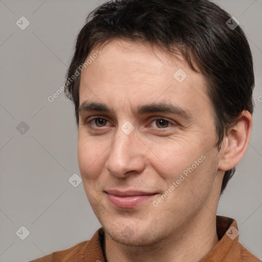 Joyful white adult male with short  brown hair and brown eyes