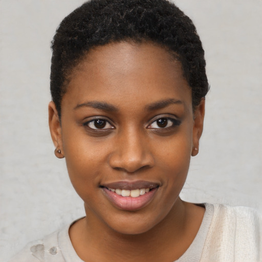 Joyful black young-adult female with short  brown hair and brown eyes