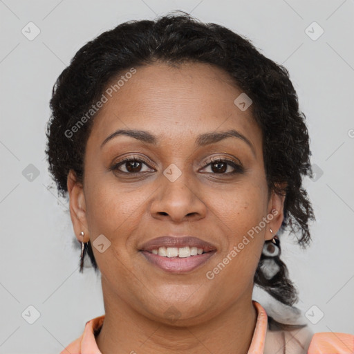 Joyful black adult female with medium  brown hair and brown eyes