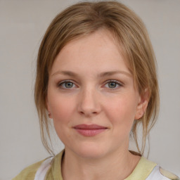 Joyful white young-adult female with medium  brown hair and blue eyes