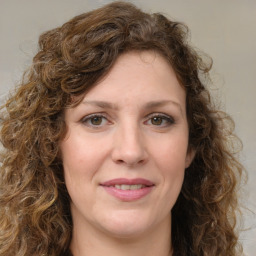 Joyful white young-adult female with long  brown hair and green eyes