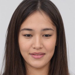 Joyful asian young-adult female with long  brown hair and brown eyes