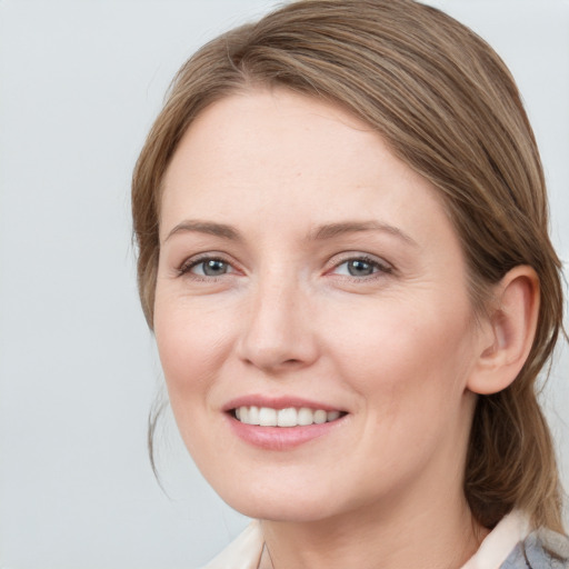 Joyful white young-adult female with medium  brown hair and blue eyes