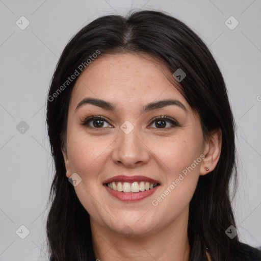 Joyful latino young-adult female with long  brown hair and brown eyes