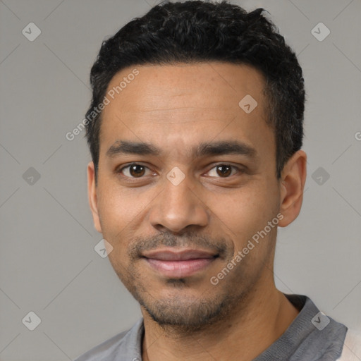 Joyful black young-adult male with short  black hair and brown eyes