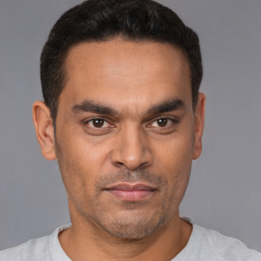 Neutral latino young-adult male with short  black hair and brown eyes