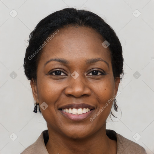 Joyful black young-adult female with short  black hair and brown eyes