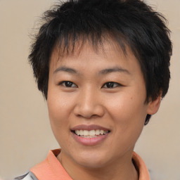 Joyful asian young-adult female with short  brown hair and brown eyes