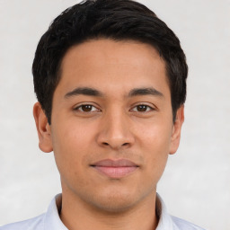 Joyful latino young-adult male with short  brown hair and brown eyes