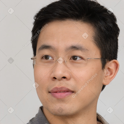 Joyful asian young-adult male with short  brown hair and brown eyes