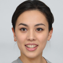 Joyful asian young-adult female with short  brown hair and brown eyes