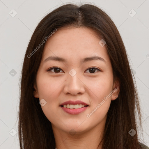 Joyful asian young-adult female with long  brown hair and brown eyes