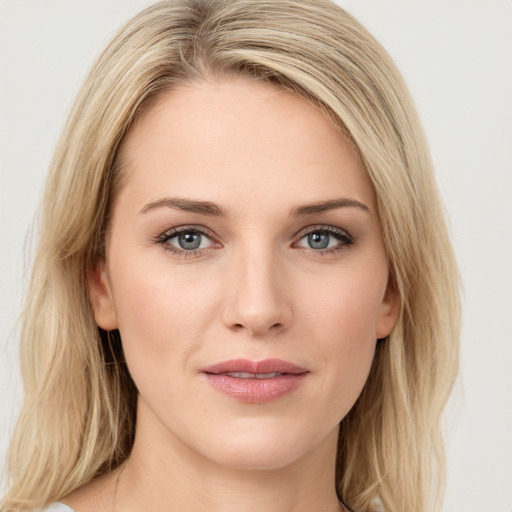 Joyful white young-adult female with long  brown hair and blue eyes