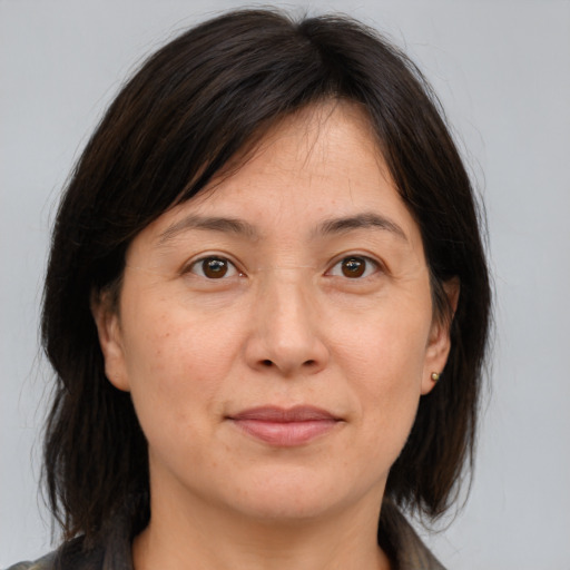 Joyful white adult female with medium  brown hair and brown eyes