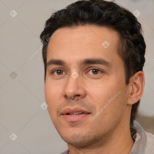 Joyful white young-adult male with short  black hair and brown eyes