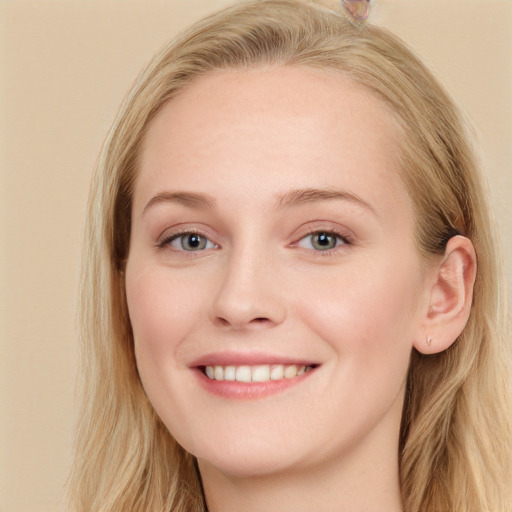 Joyful white young-adult female with long  brown hair and blue eyes