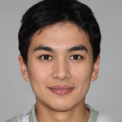Joyful latino young-adult male with short  brown hair and brown eyes