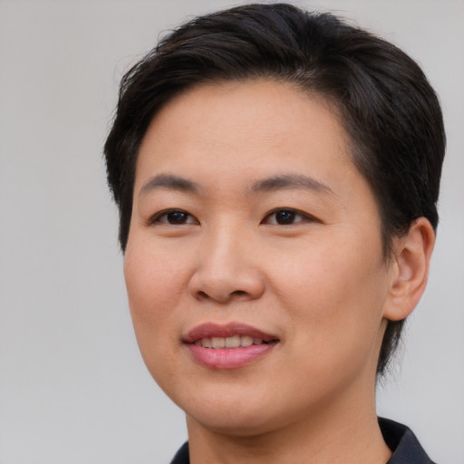 Joyful asian young-adult female with short  brown hair and brown eyes