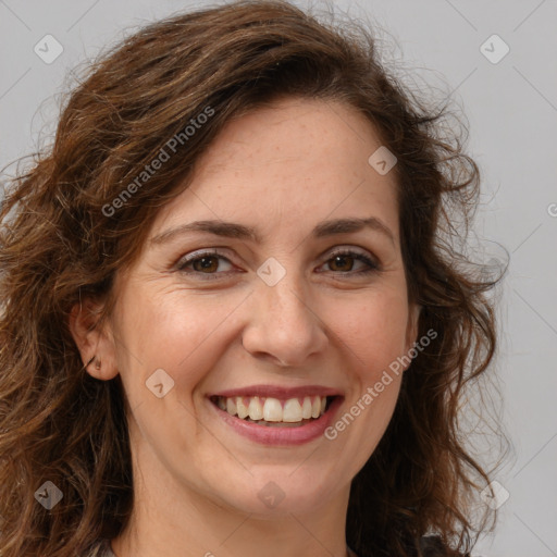 Joyful white adult female with long  brown hair and brown eyes