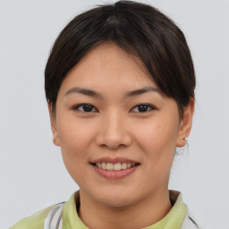 Joyful asian young-adult female with short  brown hair and brown eyes