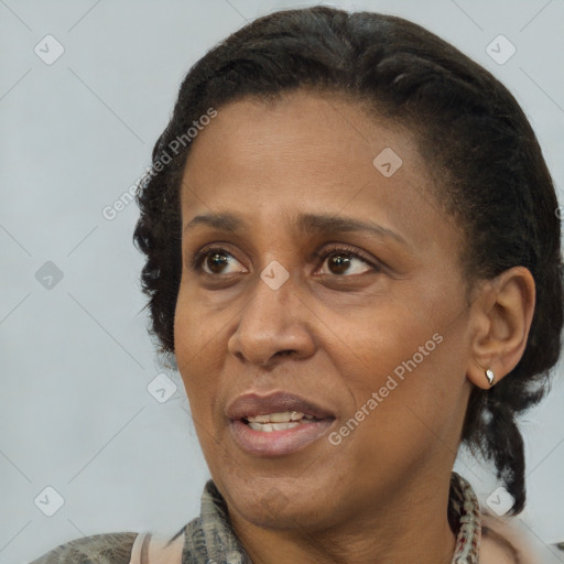 Joyful black adult female with medium  black hair and brown eyes