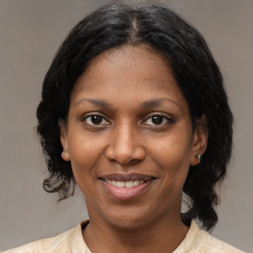 Joyful latino young-adult female with medium  black hair and brown eyes
