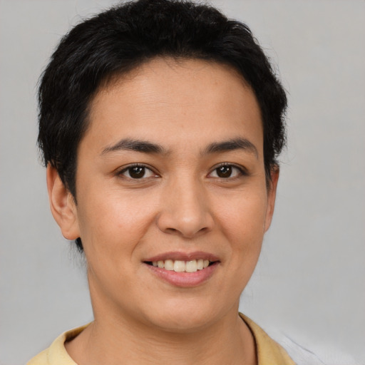 Joyful latino young-adult female with short  brown hair and brown eyes