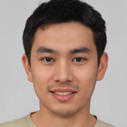 Joyful asian young-adult male with short  black hair and brown eyes