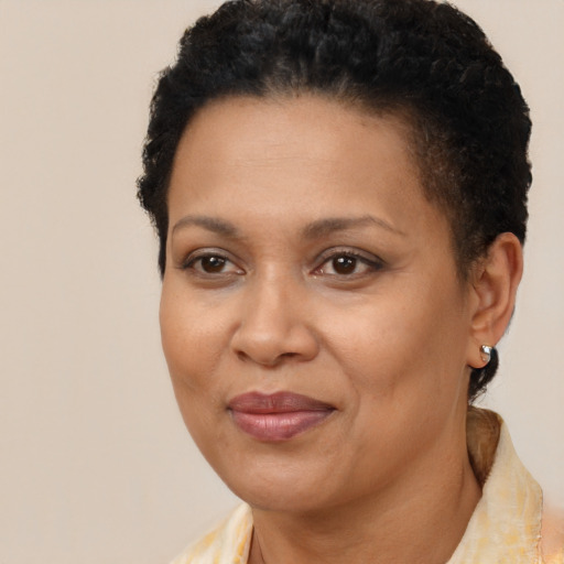 Joyful black adult female with short  brown hair and brown eyes