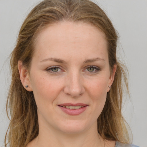 Joyful white adult female with medium  brown hair and grey eyes