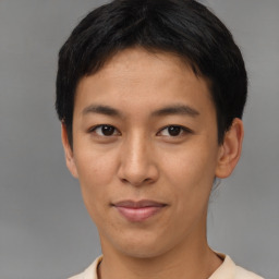 Joyful latino young-adult male with short  brown hair and brown eyes